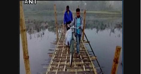 No concrete bridge to his village: Assam boy carries brother's body on cycle