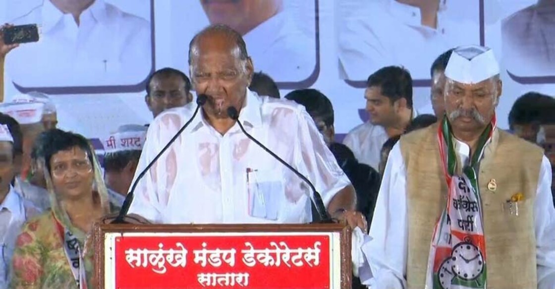 Pune: NCP President Sharad Pawar addresses in pouring rain at an election rally in Pune on Oct 18, 2019. (Photo: IANS)