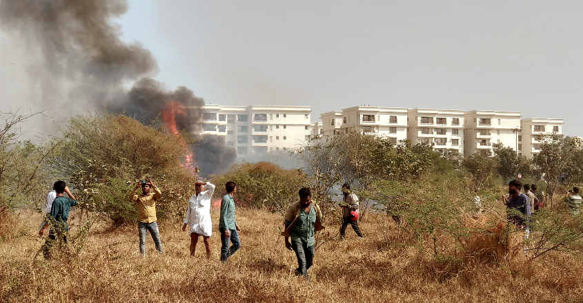 mirage-accident-2 People gather near the site of a crashed Indian Air Force's Mirage 2000 trainer aircraft in Bengaluru. Reuters
