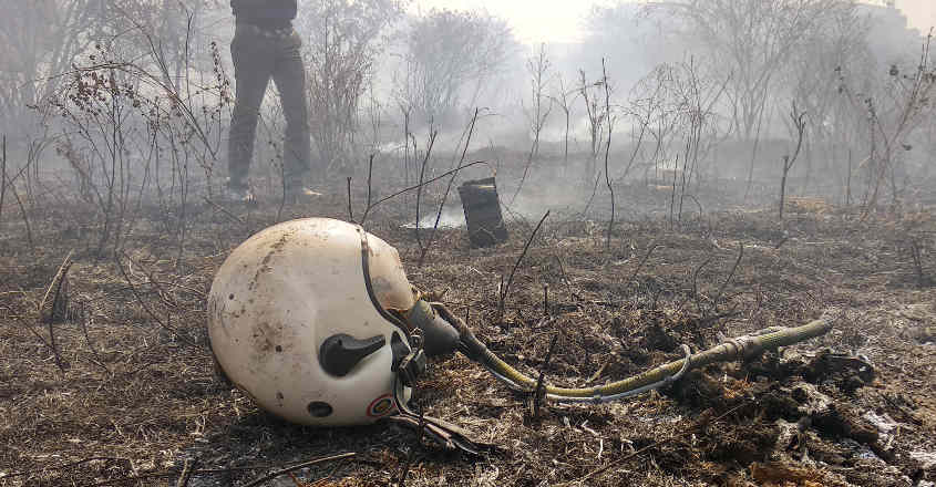 mirage-accident-4 A helmet is seen lying near the site of a crashed Indian Air Force's Mirage 2000 trainer aircraft in Bengaluru, February 1, 2019. REUTERS/Ismail Shakil