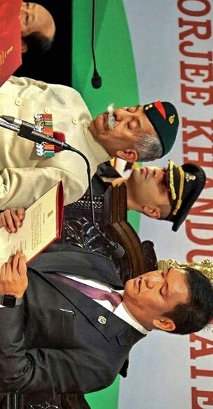 Arunachal Pradesh Governor Brig (Retd) BD Mishra (L) administers oath to Pema Khandu as the state's chief minister for his second term during a swearing-in ceremony, in Itanagar, on Wednesday. PTI