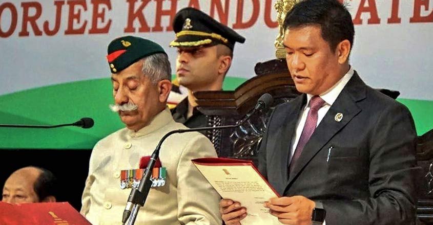 Arunachal Pradesh Governor Brig (Retd) BD Mishra (L) administers oath to Pema Khandu as the state's chief minister for his second term during a swearing-in ceremony, in Itanagar, on Wednesday. PTI