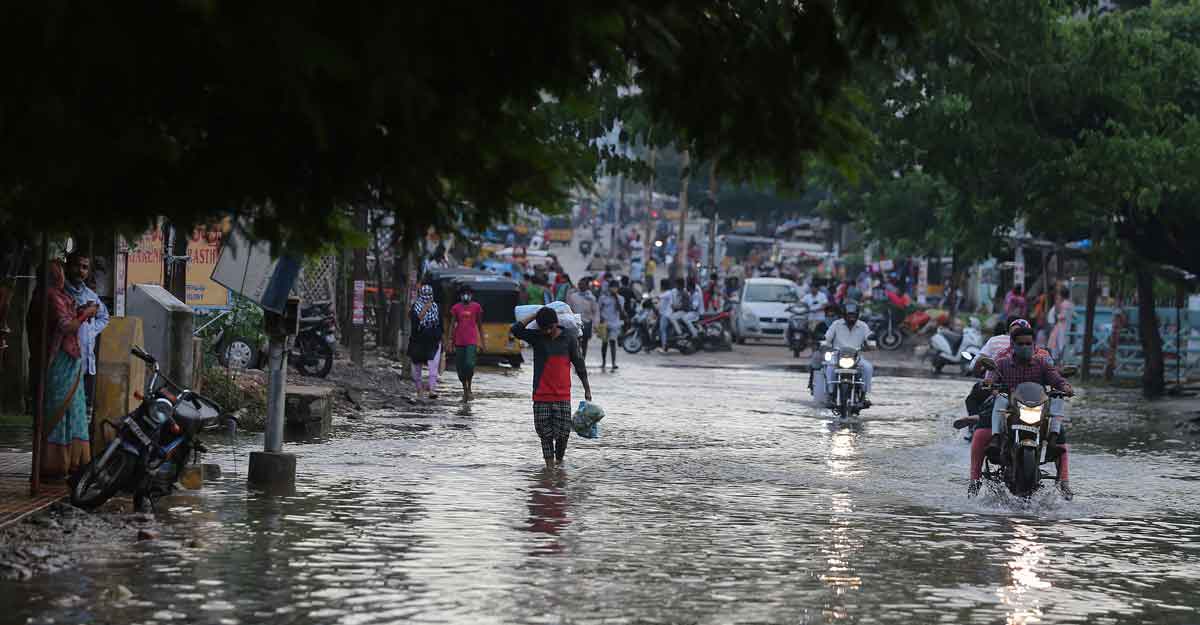 Commuters wade through receding floodwaters after heavy rainfall in Hyderabad Commuters wade through receding floodwaters after heavy rainfall in Hyderabad