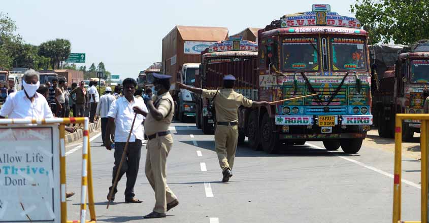Health officials an policemen stop vehicles at the Tamil Nadu-Andra Pradesh interstate border during a government-imposed lockdown as a preventive measure against the COVID-19 coronavirus, on outskirts of Chennai on March 24, 2020. (Photo by Arun SANKAR / AFP)
