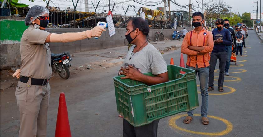 COVID-19 LIVE | Coronavirus cases cross 5,000 in Maharshtra, India's tally at 20,471 A security personnel conducts thermal scanning of vendors before they enter the Okhla vegetable market during the nationwide lockdown, in wake of the coronavirus pandemic, in New Delhi. Photo: PTI