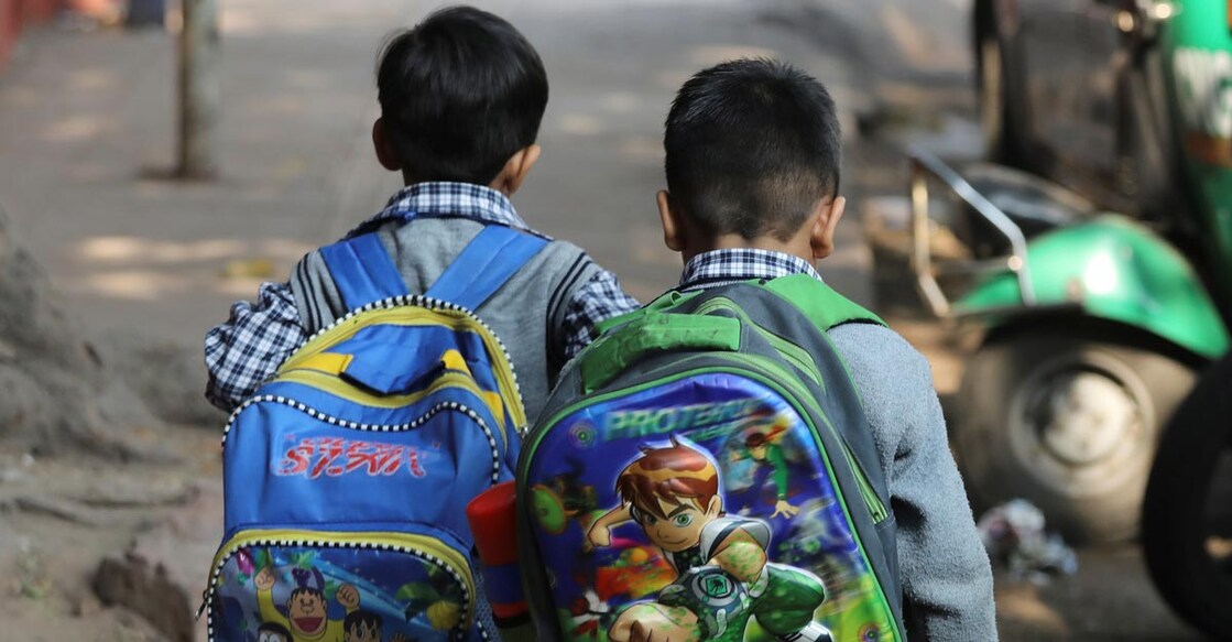 Schoolchildren walk along a footpath in New Delhi, India, November 27, 2018. REUTERS/Anushree Fadnavis/Files