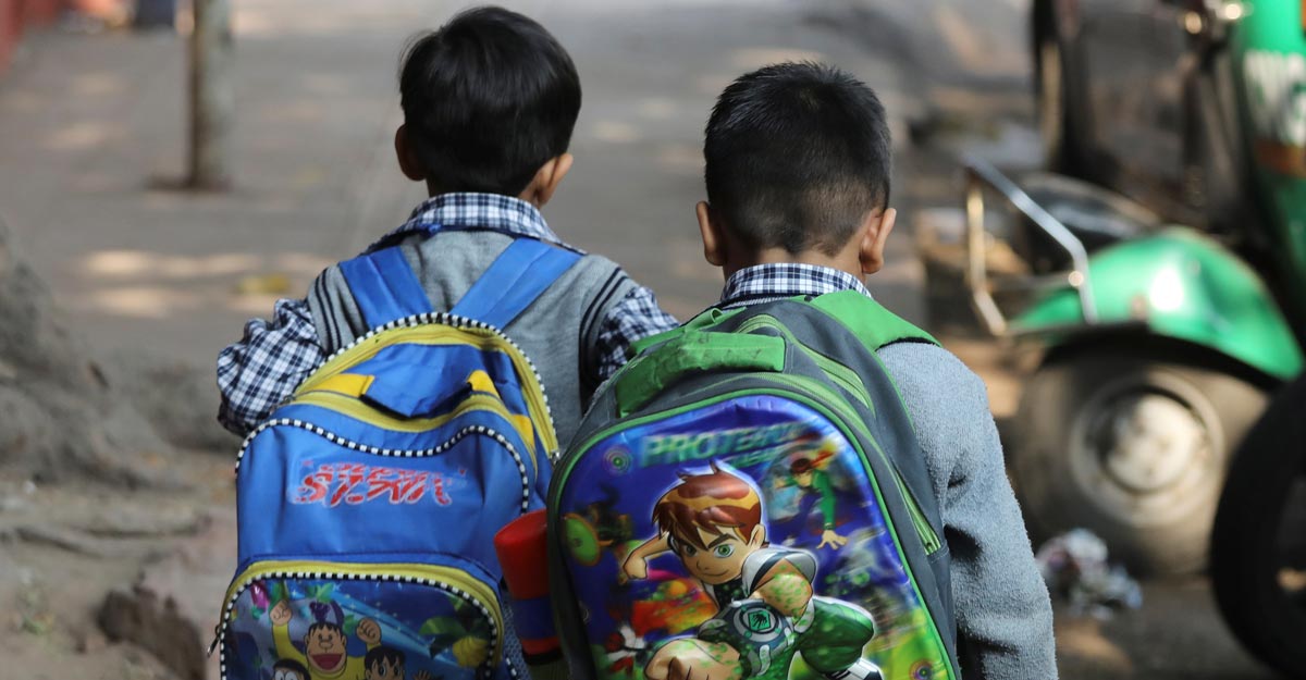 Schoolchildren walk along a footpath in New Delhi, India, November 27, 2018. REUTERS/Anushree Fadnavis/Files