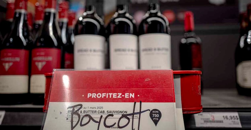 CANADA-US-MEXICO-CHINA-TARIFF-TRADE A grafitto calling to boycott an American wine is seen at a liquor store in Montreal, Canada, on February 3, 2025. US President Donald Trump paused tariffs on Mexico for one month after last-minute talks Monday -- but there was no breakthrough yet in negotiations with Canada on an issue that has sparked fears of a global trade war. (Photo by ANDREJ IVANOV / AFP)