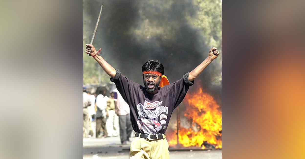 Gujarat riots A Bajrang Dal activist armed with an iron rod on the streets of Shahpur, Ahmedabad on February 28, 2002. Photo: AFP