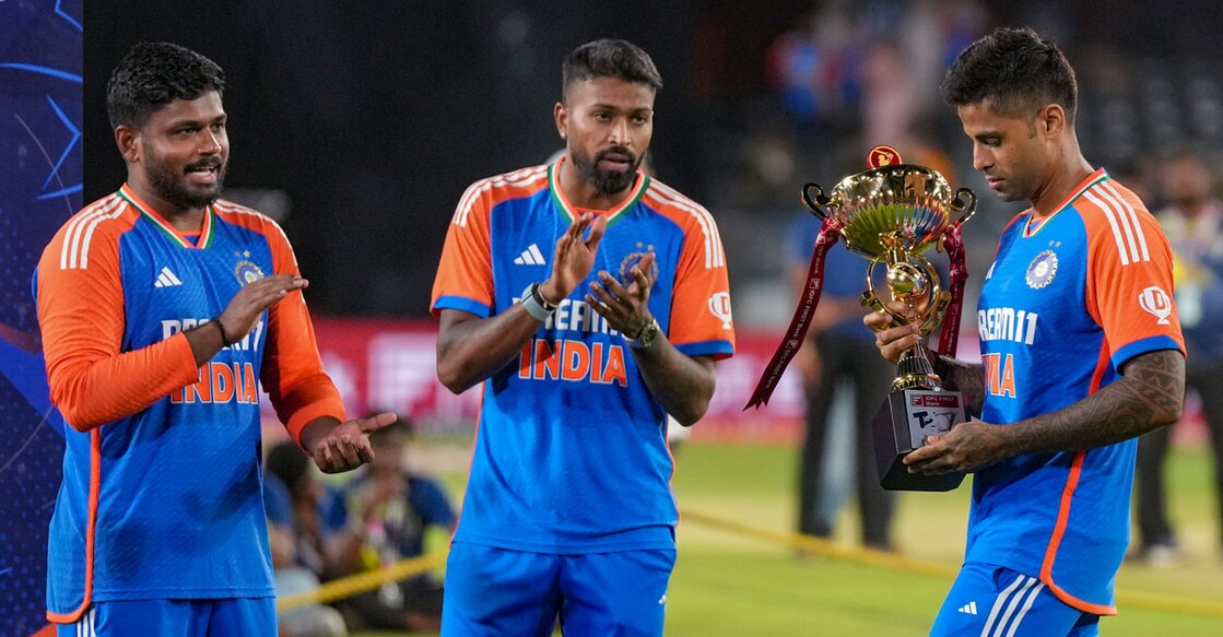 India's captain Suryakumar Yadav holds the championship trophy as teammates Hardika Pandya and Sanju Samson applaud during the presentation ceremony after winning the third and final T20 International against Bangladesh at the Rajiv Gandhi International Cricket Stadium, in Hyderabad, Saturday. Photo: PTI