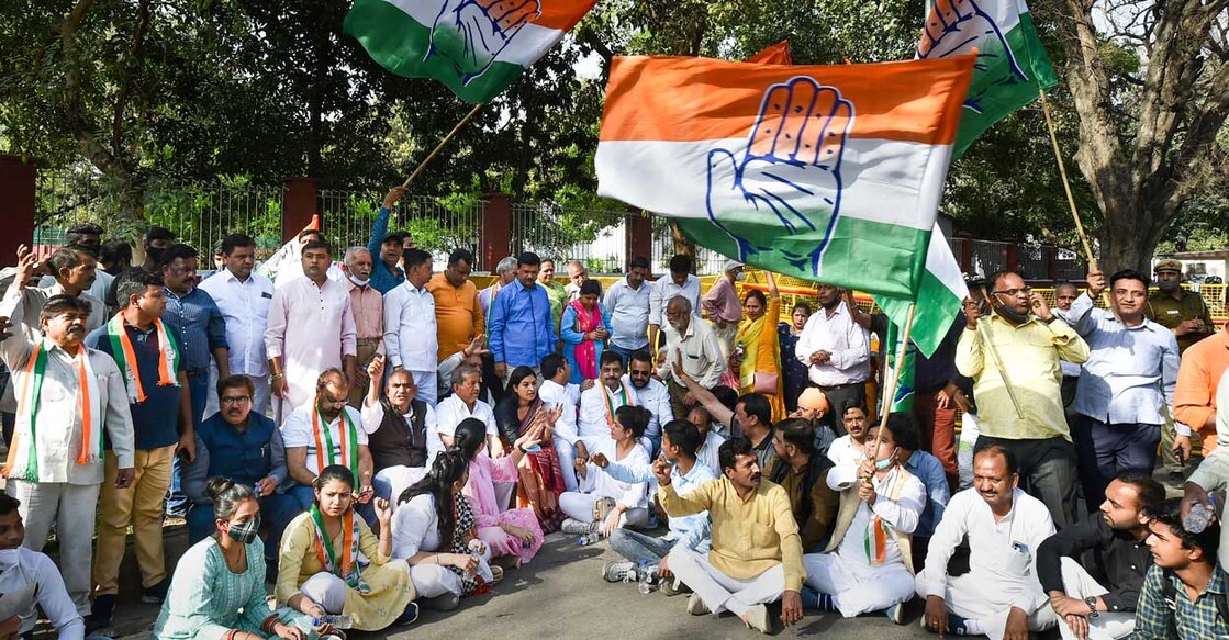 Congress workers stage a protest in favour of leadership of Gandhis, ahead of Congress Working Committee (CWC) meeting over party's debacle in recent Assembly elections of five states, outside AICC, in New Delhi, Sunday, March 13, 2022. Photo: Arun Sharma