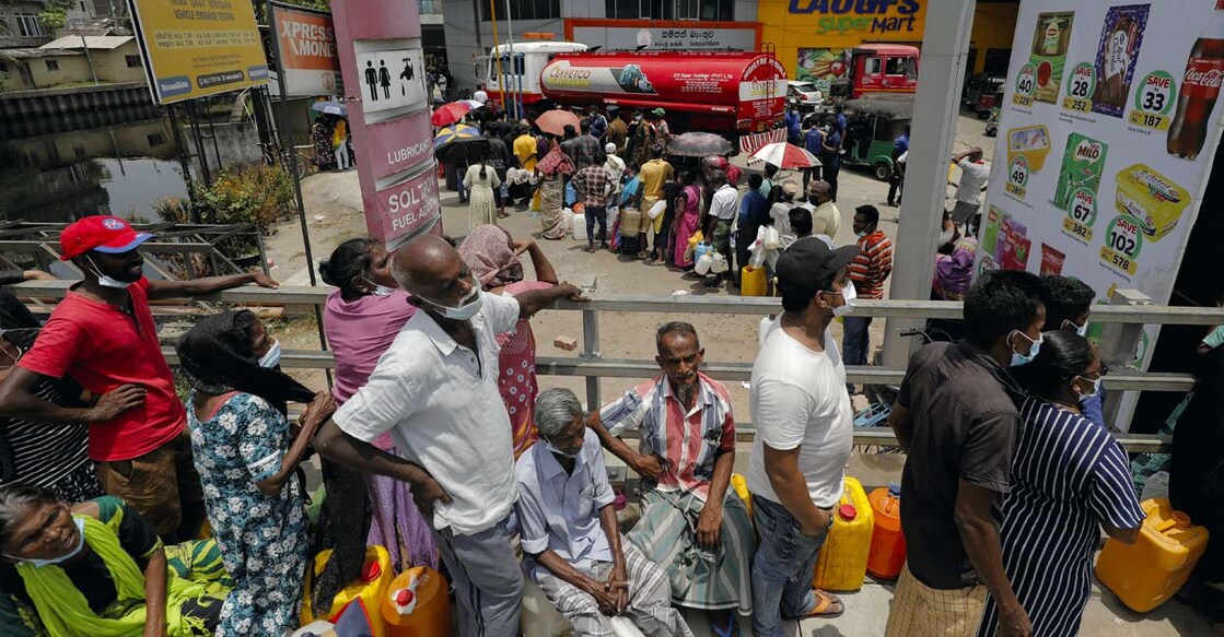 People stand in a long queue to buy kerosene oil for kerosene cookers amid a shortage of domestic gas due to country's economic crisis, at a fuel station in Colombo on March 21, 2022. REUTERS/Dinuka Liyanawatte