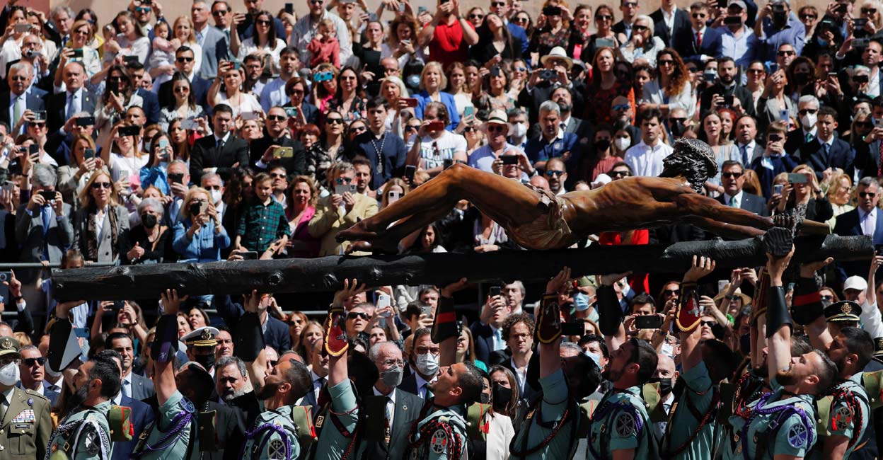 Christ Spanish legionnaires carry a statue of the Christ of Mena outside a church, during a ceremony ahead of the Mena brotherhood procession, after processions were cancelled for the last two years due to the coronavirus disease (COVID-19) pandemic, in Malaga, Spain, April 14, 2022. Reuters/Jon Nazca