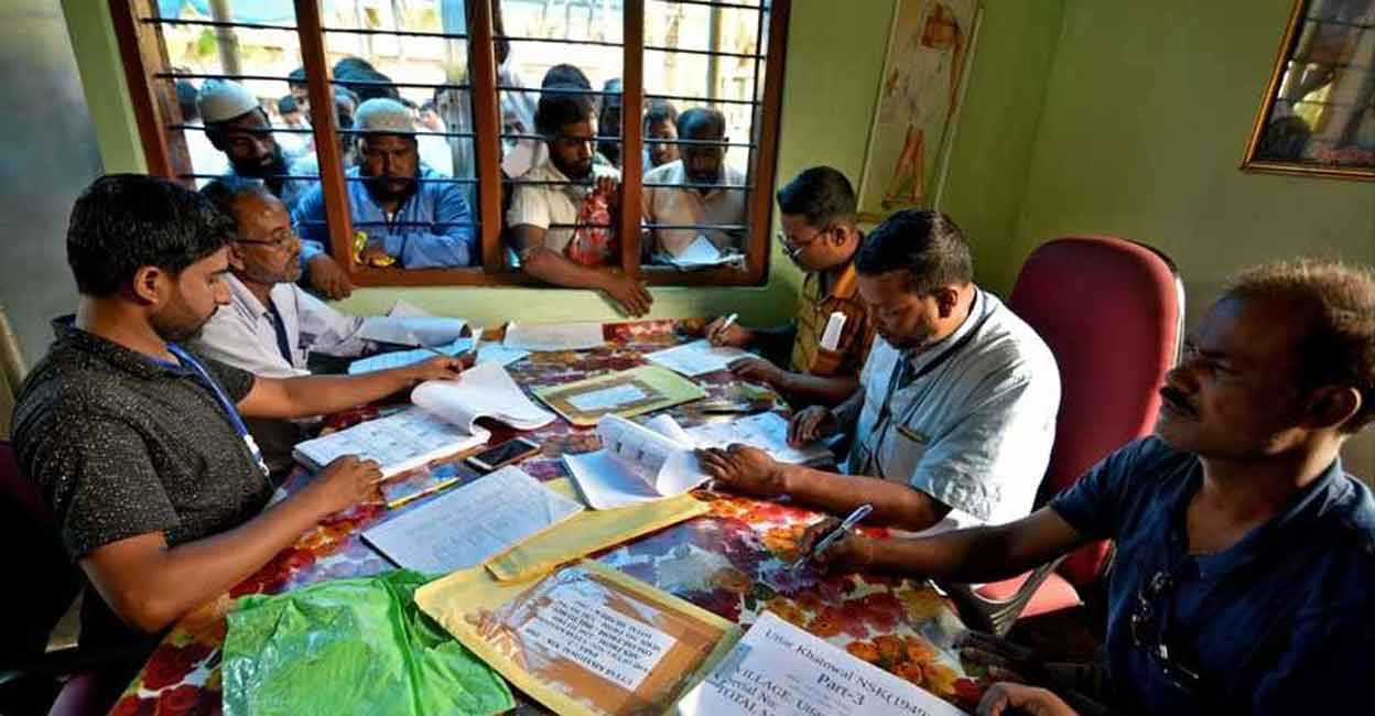 People wait to check their names on the draft list at the National Register of Citizens (NRC) centre at a village in Nagaon district, Assam in July 30, 2018. File Photo: Reuters.