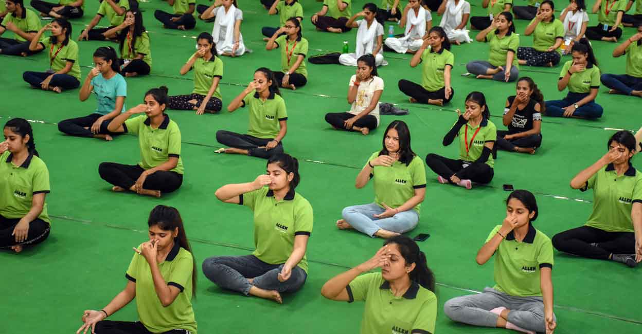 PTI12_22_2022_000107B Students participate in a yoga session, in Kota. From Yoga sessions and Zumba classes to 24X7 helpline, and mental wellness workshops to a dedicated team of counsellors on campus, the coaching institutes in Kota say they take multiple measures to help students get through the stress and anxiety of students preparing for competitive exams. Photo: PTI Photo/Gunjan Sharma