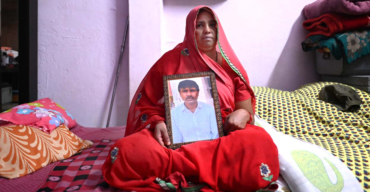 yashodaa Jashoda Sahu Teli holds a picture of her slain husband Kanhaiya Lal, who was allegedly killed by two Muslim men for supporting BJP's Nupur Sharma for her remarks about the Prophet Mohammed. Photo: Sajjad HUSSAIN / AFP