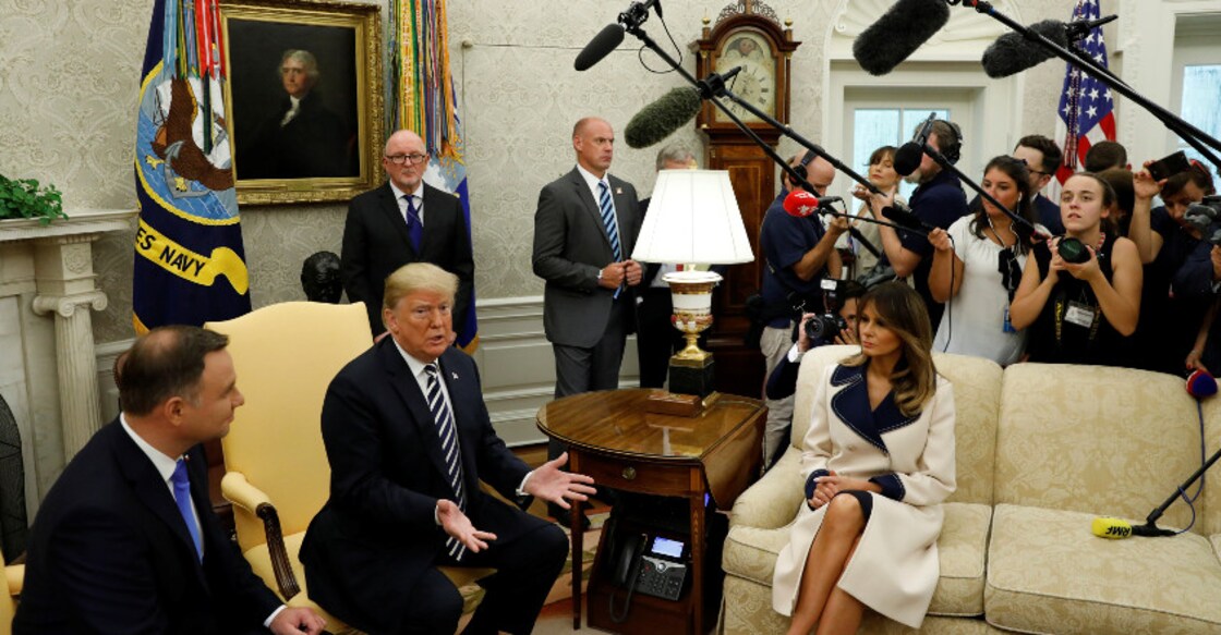 US President Donald Trump speaks next to first lady Melania Trump during a meeting with Poland's President Andrzej Duda (L) in the Oval Office of the White House in Washington. Photo: Reuters