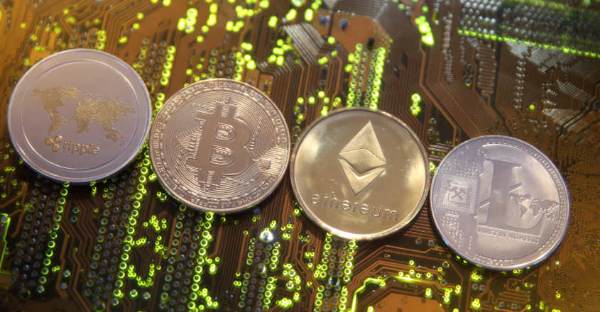 Representations of the Ripple, Bitcoin, Etherum and Litecoin virtual currencies are seen on a PC motherboard in this illustration picture, February 13, 2018. Reuters