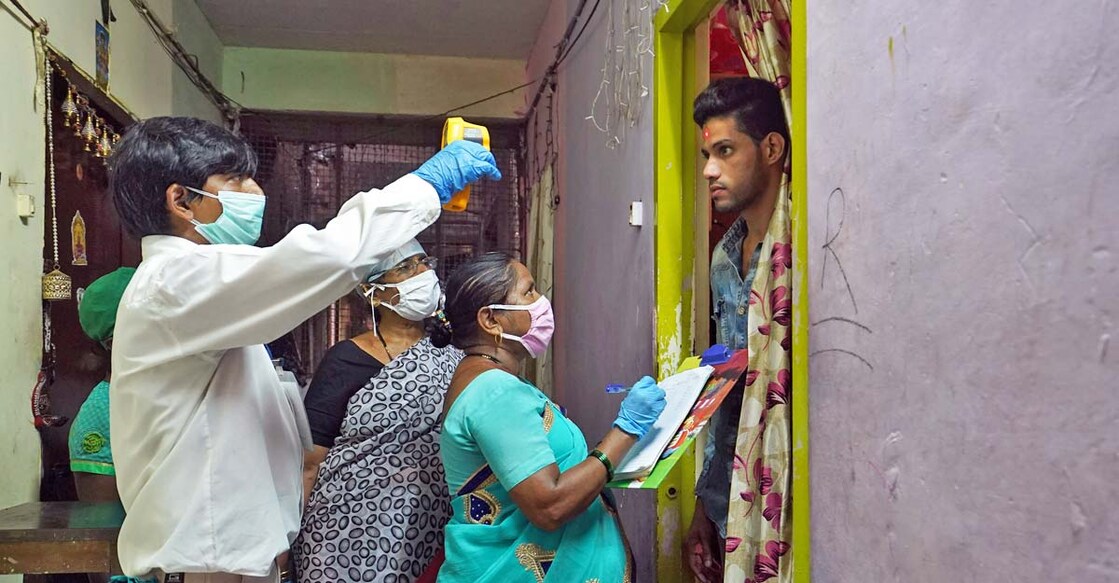 Health workers wearing protective face masks check the temperature of a resident at a housing society during a checkup campaign for the coronavirus disease (COVID-19) in Mumbai, July 21, 2020. REUTERS/Hemanshi Kamani Health workers wearing protective face masks check the temperature of a resident at a housing society during a checkup campaign for the coronavirus disease (COVID-19) in Mumbai, July 21, 2020. REUTERS/Hemanshi Kamani