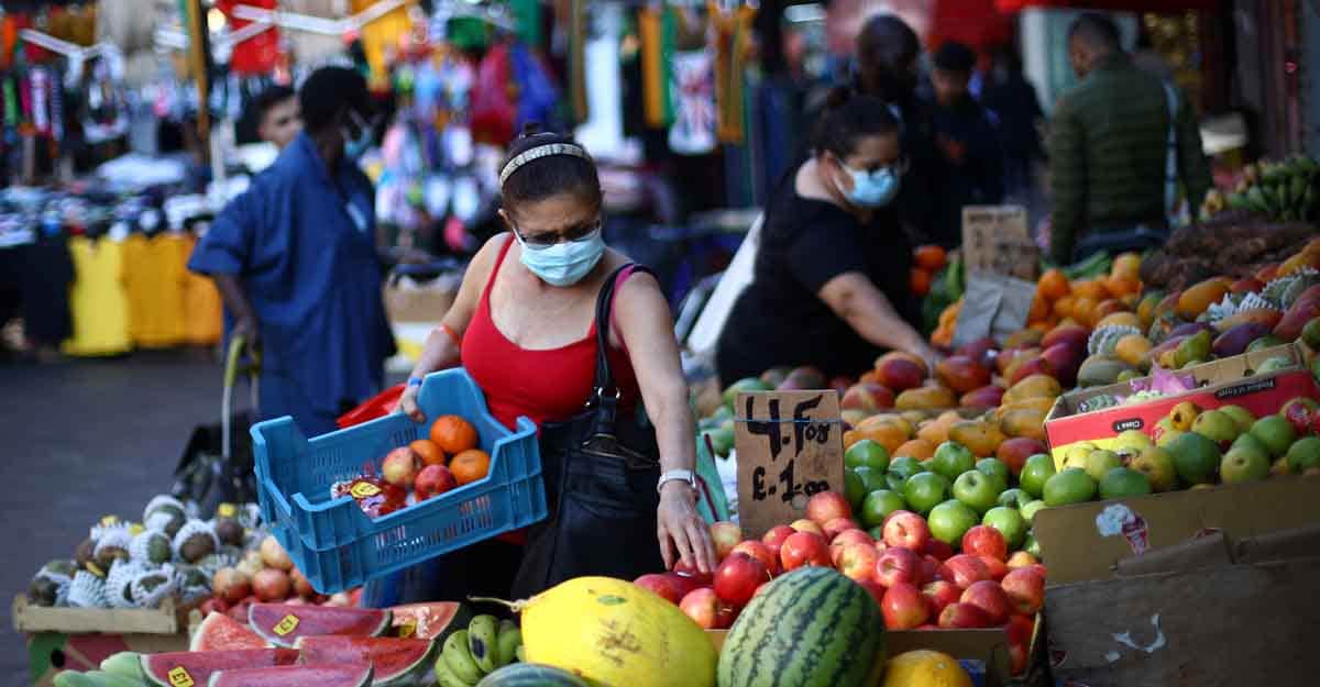 HEALTH-CORONAVIRUS-BRITAIN A woman wears a protective face mask as she shops at a market, amid the spread of the coronavirus disease (COVID-19), in Brixton, London, Britain September 21, 2020. REUTERS/Hannah McKay