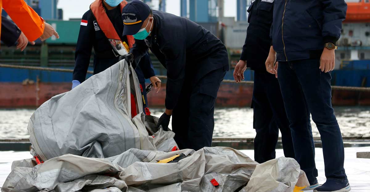 Indonesian rescue members carry what is believed to be the remains of the Sriwijaya Air plane flight SJ182 which crashed into the sea, at Jakarta International Container Terminal port in Jakarta, Indonesia, January 10, 2021. REUTERS/Ajeng Dinar Ulfiana