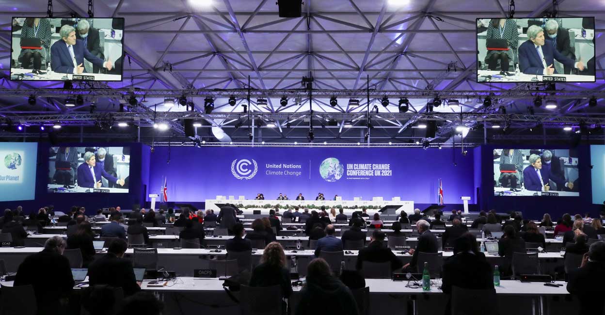 COP26: Climate deal struck at Glasgow with India's coal pushback US climate envoy John Kerry is seen on multiple screens as he speaks at the UN Climate Change Conference (COP26) in Glasgow, Scotland, November 13, 2021. Reuters/Yves Herman