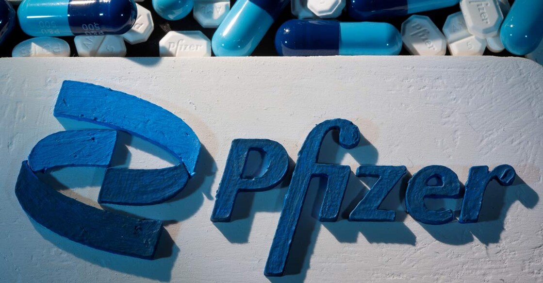 HEALTH-CORONAVIRUS-PFIZER-TREATMENTS A 3D printed Pfizer logo is placed near medicines from the same manufacturer. REUTERS/Dado Ruvic