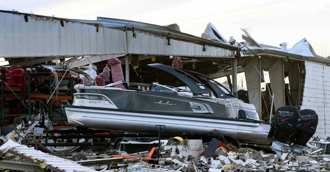A boat sits at rest after being sucked out of a marine dealership by a tornado in Mayfield, Kentucky, on December 11, 2021. Photo: John Amis / AFP