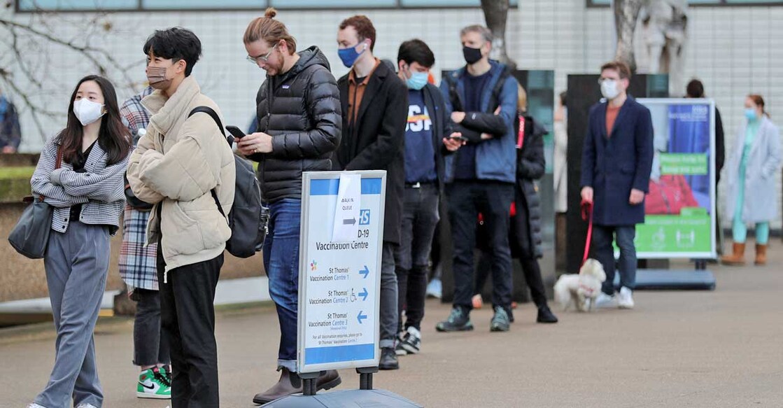 COVID People queue outside a coronavirus disease (COVID-19) vaccination centre at St Thomas' Hospital as the pandemic continues, in London, Britain, December 12, 2021. Reuters/May James