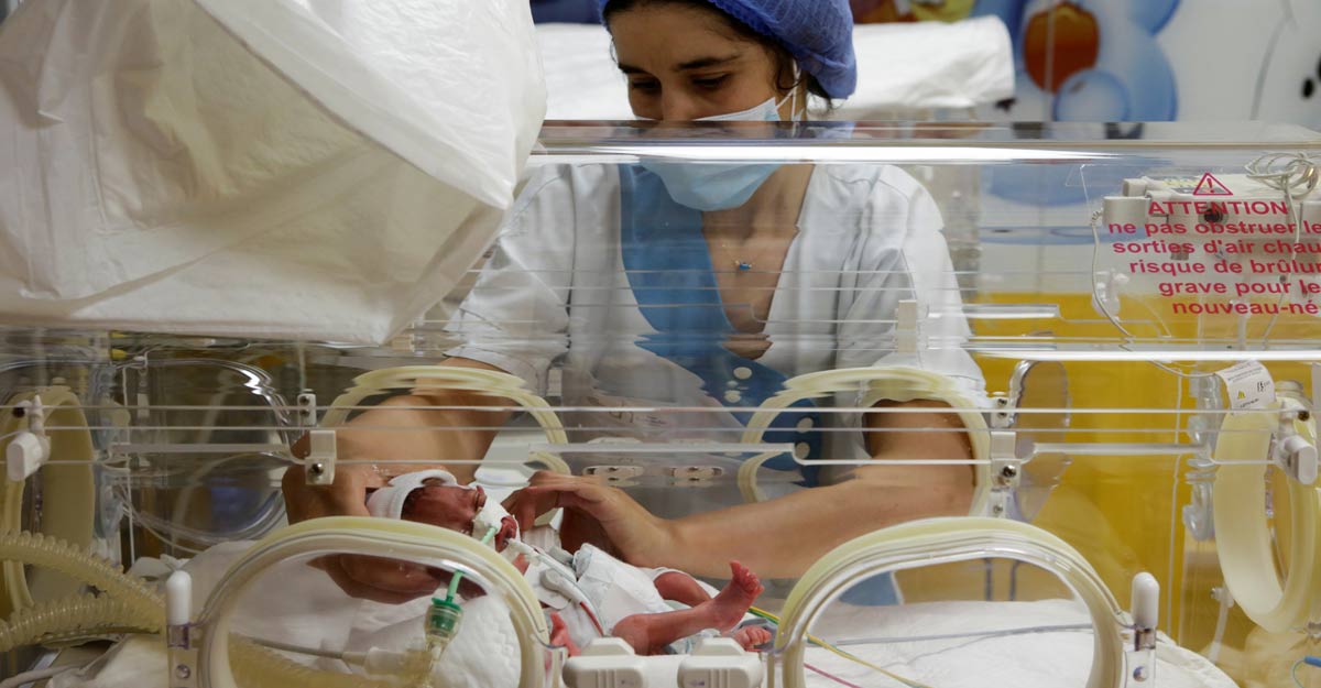A nurse takes care of one of the newborn nonuplets A nurse takes care of one of the newborn nonuplets