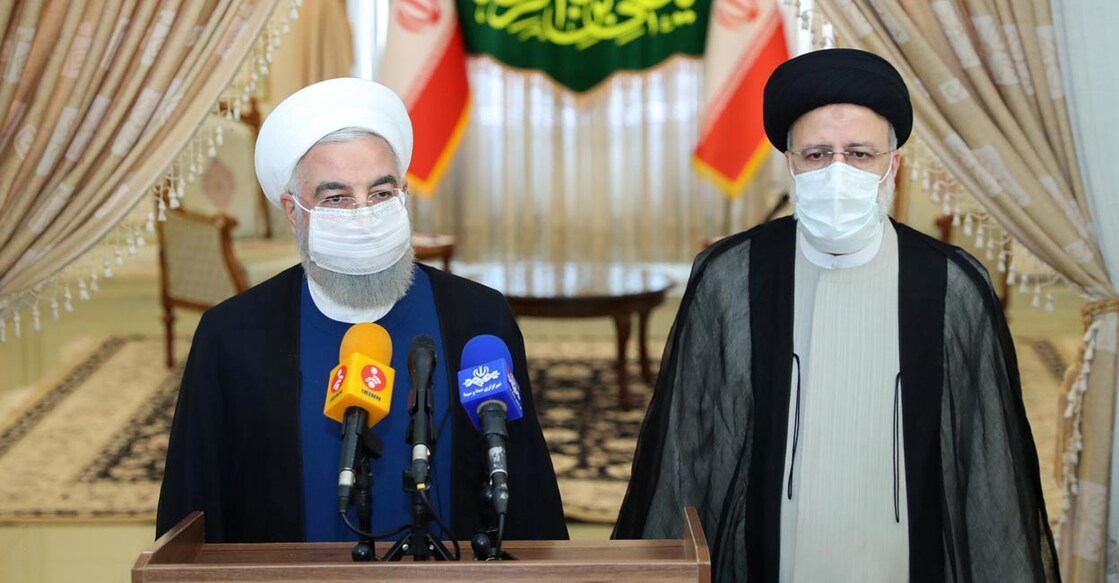 Iran's outgoing President Hassan Rouhani and Iran's President-elect Ebrahim Raisi 