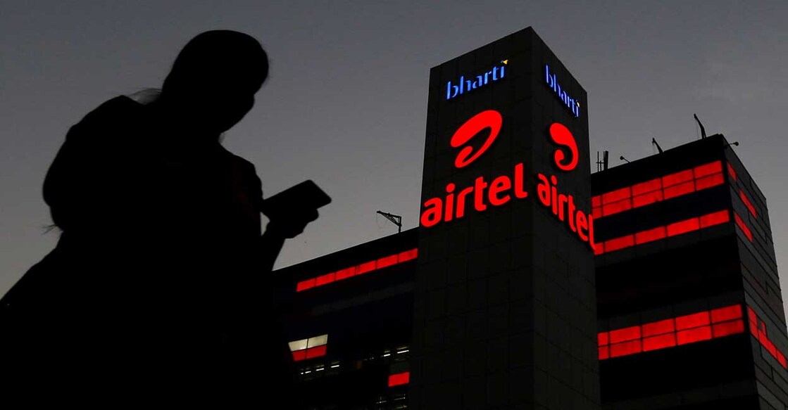 A girl checks her mobile phone as she walks past the Bharti Airtel office building in Gurugram, previously known as Gurgaon, on the outskirts of New Delhi, India April 21, 2016. Reuters/Adnan Abidi/File Photo