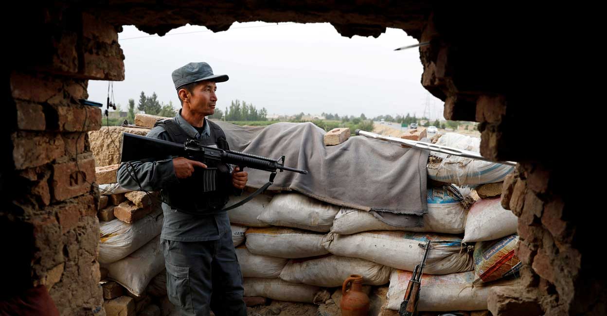 An Afghan policeman keeps watch at the check post on the outskirts of Kabul, Afghanistan July 13, 2021. Reuters/Mohammad Ismail//File Photo