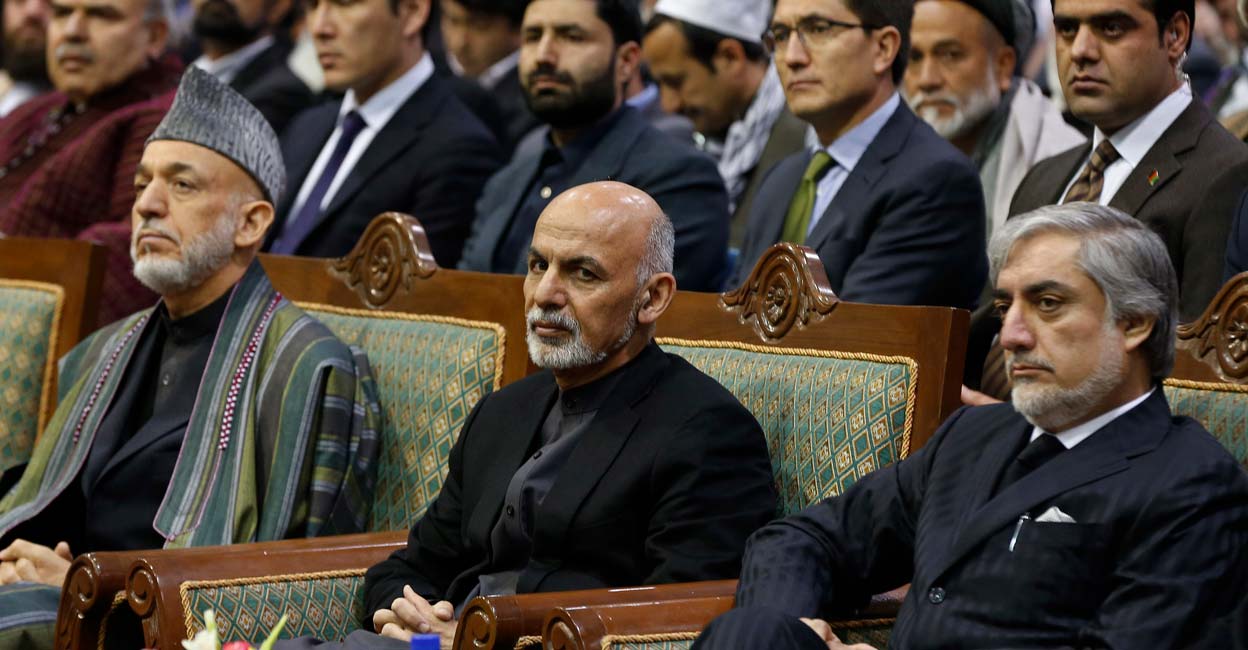 AFGHANISTAN-POLITICS Afghan President Ashraf Ghani (C) attends a commemoration of the first death anniversary of former vice president Mohammad Qasim Fahim, also known as the Marshal of Afghanistan, in Kabul March 9, 2015. On the left is former President Hamid Karzai and Chief Executive Abdullah Abdullah is seen on the right. photo: REUTERS/Omar Sobhani