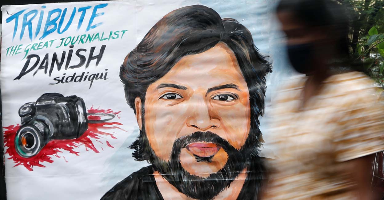Danish Siddiqui A woman walks past a painting of Reuters journalist Danish Siddiqui, after he was killed while covering a clash between Afghan security forces and Taliban fighters near a border crossing with Pakistan, outside an art school in Mumbai, India, July 16, 2021. Photo: REUTERS/Francis Mascarenhas
