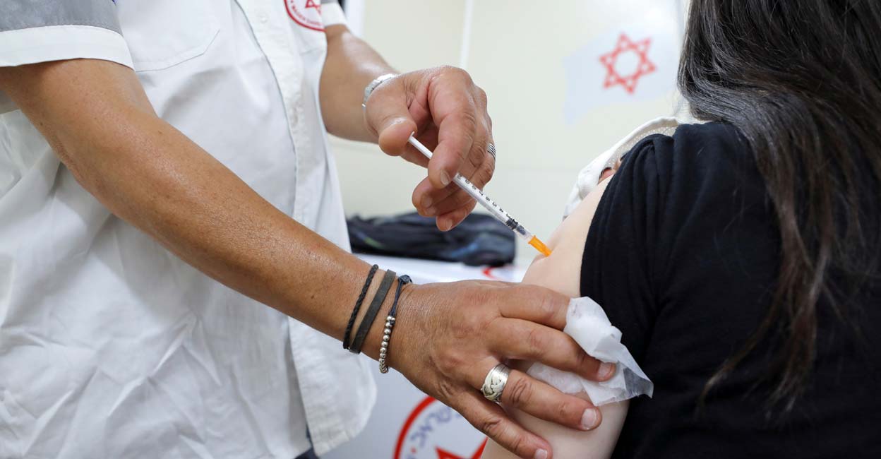 COVID A youth receives a vaccination against the coronavirus disease (COVID-19) at a mobile vaccination centre, as Israel continues to fight against the spread of the Delta variant, in Tel Aviv, Israel July 6, 2021. Reuters/Ammar Awad/File Photo