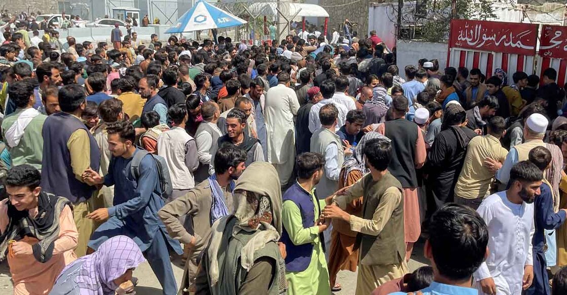 People try to get into Hamid Karzai International Airport in Kabul, Afghanistan August 16, 2021. Reuters/Stringer NO RESALES. NO ARCHIVES