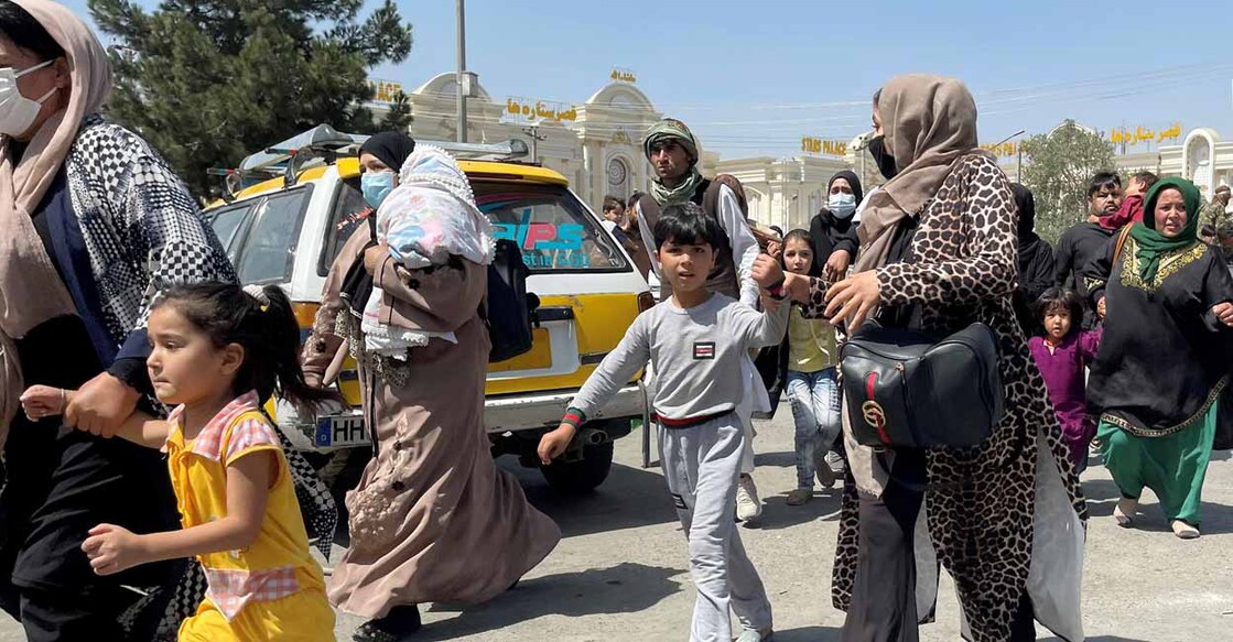 Afghans fear a return to brutal rule despite Taliban vows Women with their children try to get inside Hamid Karzai International Airport in Kabul, Afghanistan August 16, 2021. Reuters