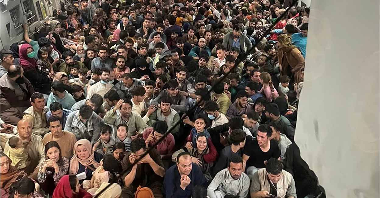 Evacuees crowd the interior of a US Air Force C-17 Globemaster III transport aircraft, carrying some 640 Afghans to Qatar from Kabul, Afghanistan, August 15, 2021. Photo: Courtesy of Defense One/via REUTERS