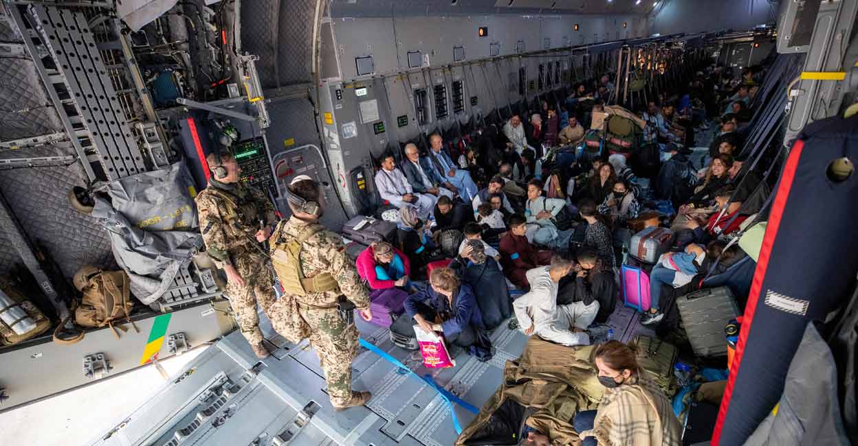 AFGHANISTAN-CONFLICT-GERMANY A handout photo obtained from Twitter via @Bw_Einsatz on August 17, 2021 shows evacuees from Afghanistan as they arrive in an Airbus A400 transport aircraft of the German Air Force Luftwaffe in Tashkent, Uzbekistan. Photo: Marc Tessensohn/Twitter @Bw_Einsatz/Handout via REUTERS