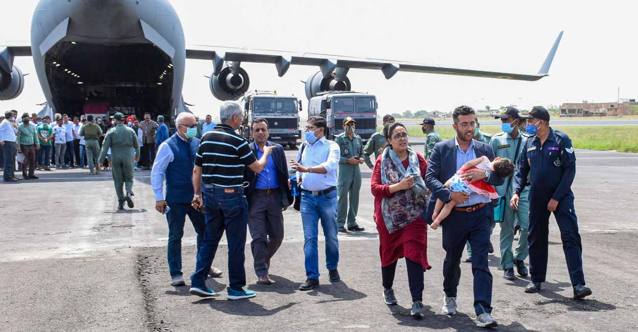 Government officials welcome Indian citizens on their arrival from crisis-hit Afghanistan by an Indian Air Force's C-17 aircraft, in Jamnagar, Tuesday, Aug. 17, 2021. PTI