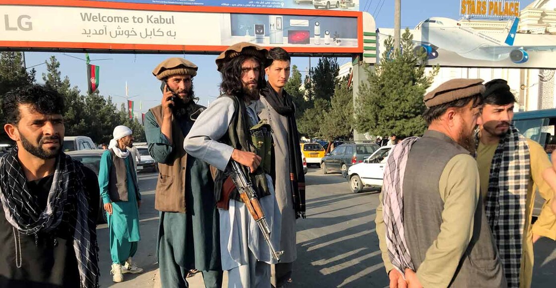 A member of Taliban (C) stands outside Hamid Karzai International Airport in Kabul, Afghanistan, August 16, 2021. REUTERS/Stringer