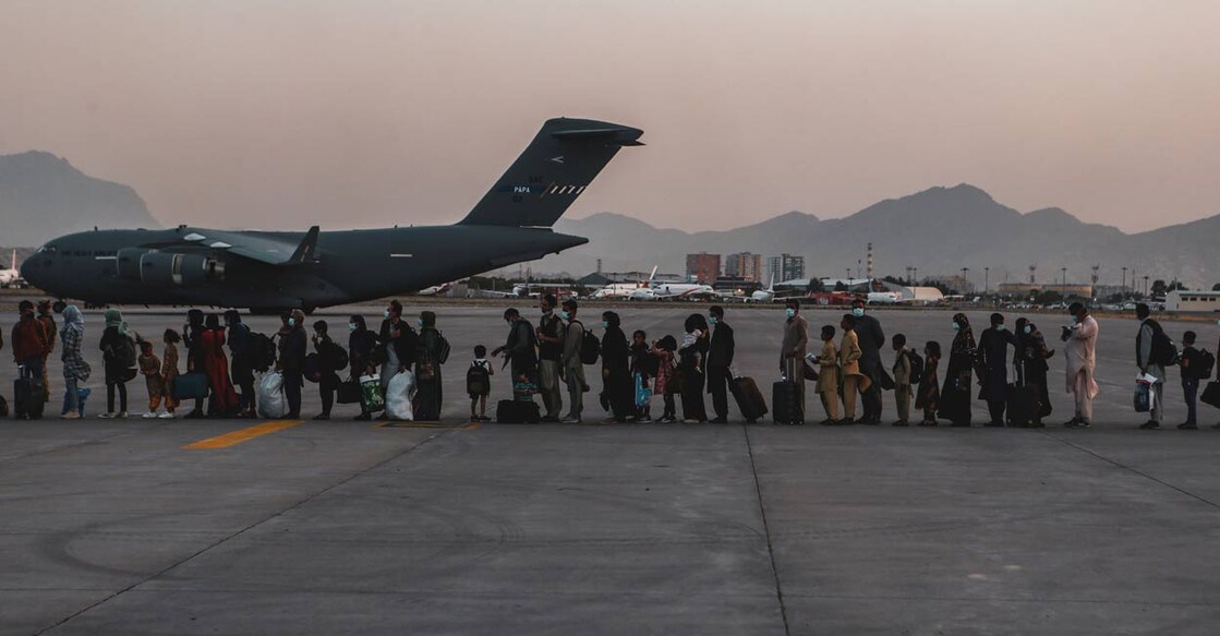 Evacuees wait to board a Boeing C-17 Globemaster III during an evacuation at Hamid Karzai International Airport in Kabul, Afghanistan, August 23, 2021. Picture taken August 23, 2021. Photo: US Marine Corps/Sgt. Isaiah Campbell/Handout via REUTERS