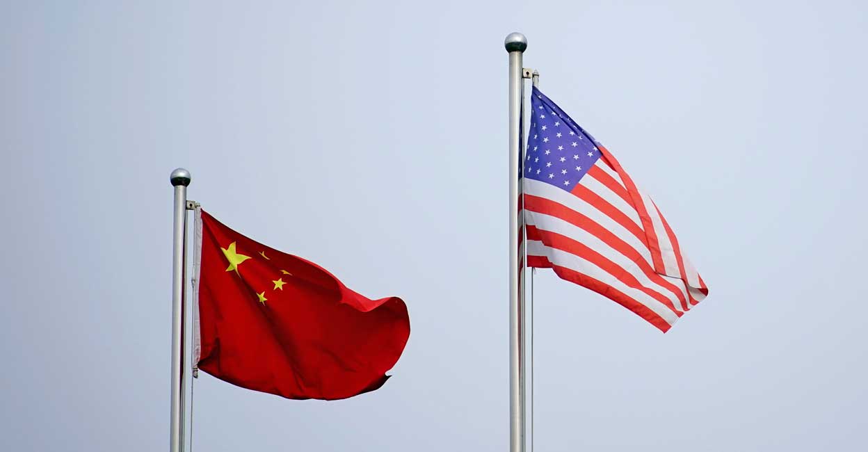 Chinese and US flags Chinese and US flags flutter outside a company building in Shanghai, China April 14, 2021. Reuters/Aly Song//File Photo