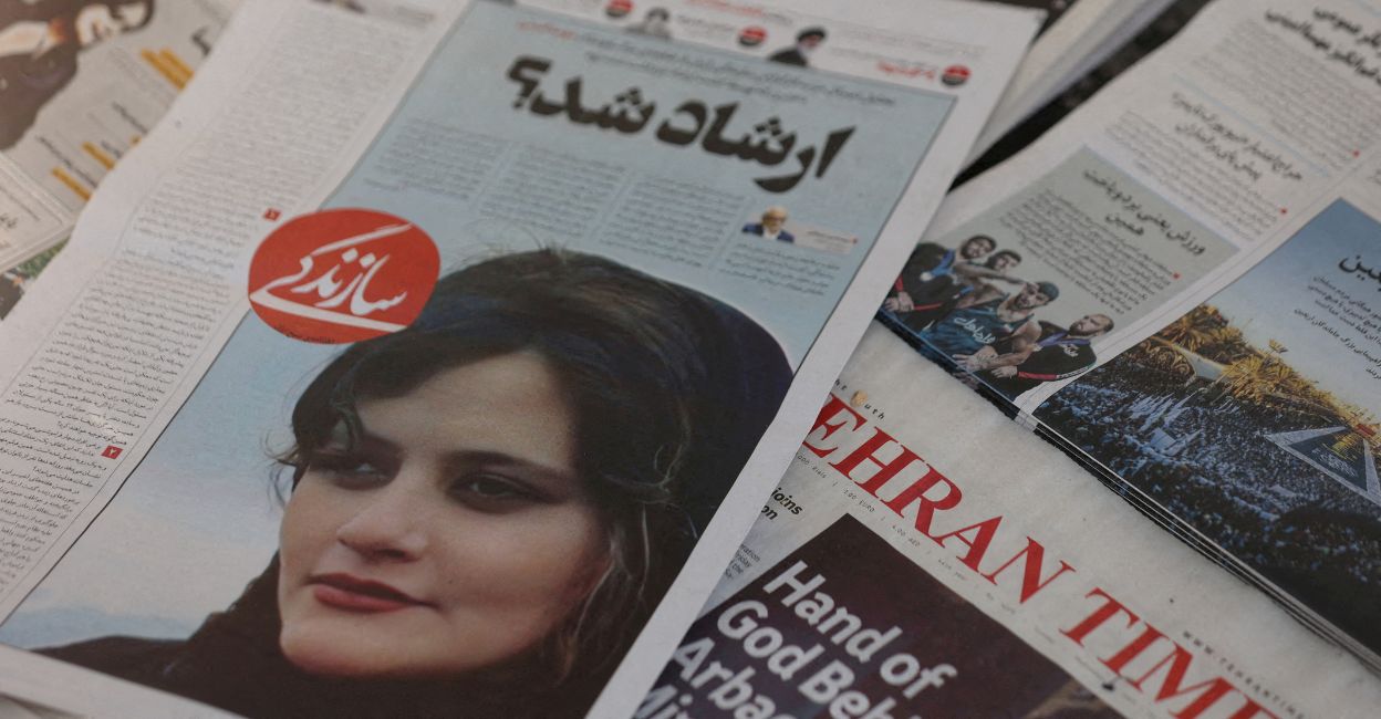 A newspaper with a cover picture of Mahsa Amini, a woman who died after being arrested by Iranian morality police is seen in Tehran, Iran, September 18, 2022. Photo: Majid Asgaripour/WANA (West Asia News Agency) via Reuters