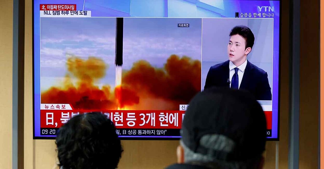 People watch a TV broadcasting a news report on North Korea firing a ballistic missile off its east coast, in Seoul, South Korea, November 3, 2022. REUTERS/ Heo Ran