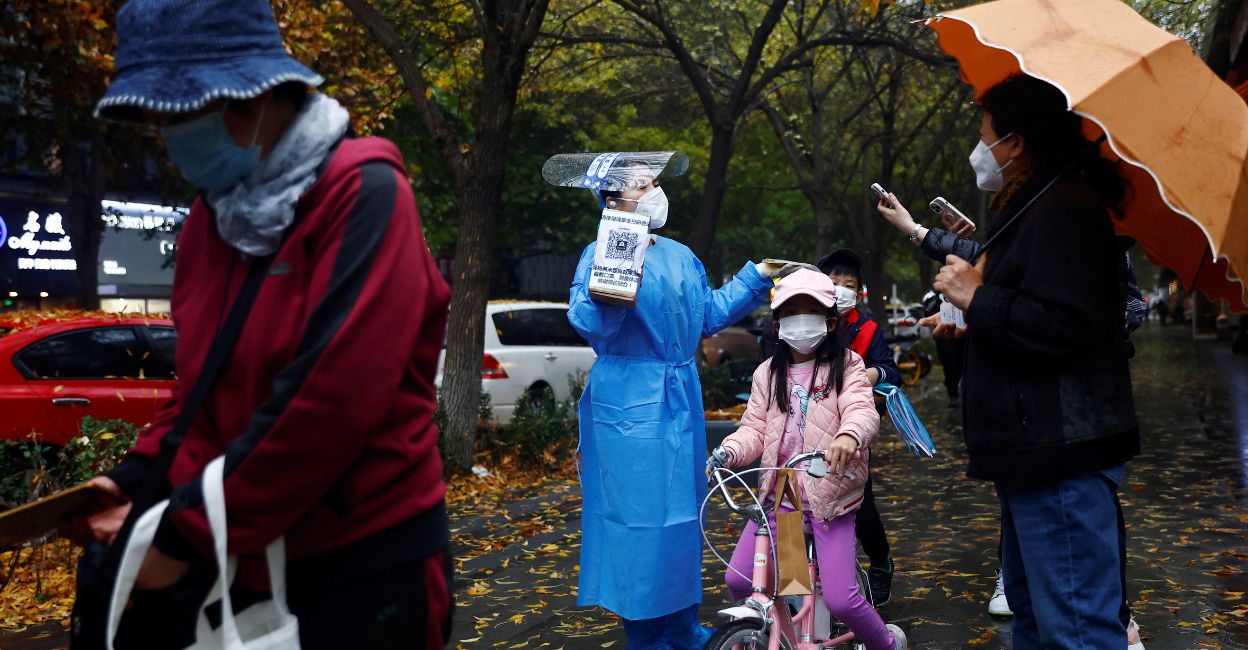 onmanorama article image - 1 An elderly person scans a QR code at a nucleic acid testing site for the coronavirus disease (COVID-19), in Beijing, China November 11, 2022. Reuters/Tingshu