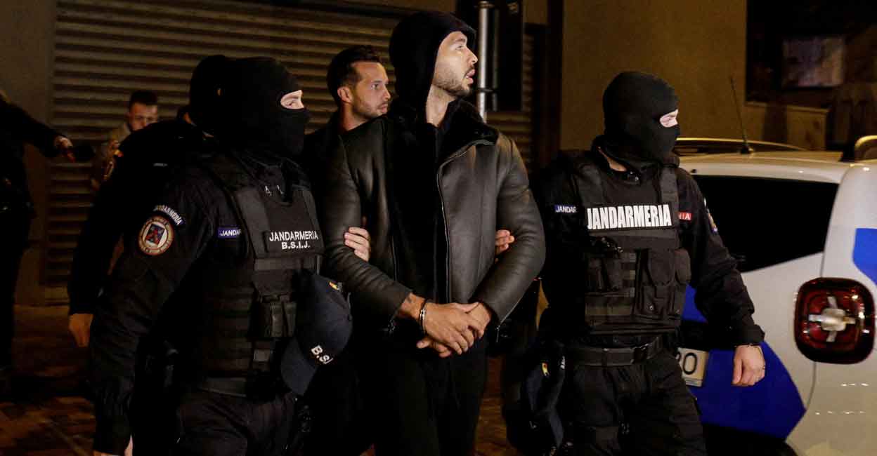 Andrew Tate and Tristan Tate are escorted by police officers outside the headquarters of the Directorate for Investigating Organized Crime and Terrorism in Bucharest (DIICOT) after being detained for 24 hours, in Bucharest, Romania, December 29, 2022. Inquam Photo: Octav Ganea via REUTERS