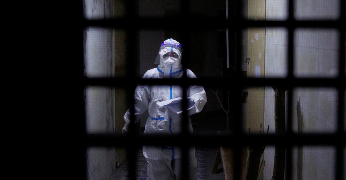 A pandemic prevention worker in a protective suit in Beijing: REUTERS/Thomas Peter