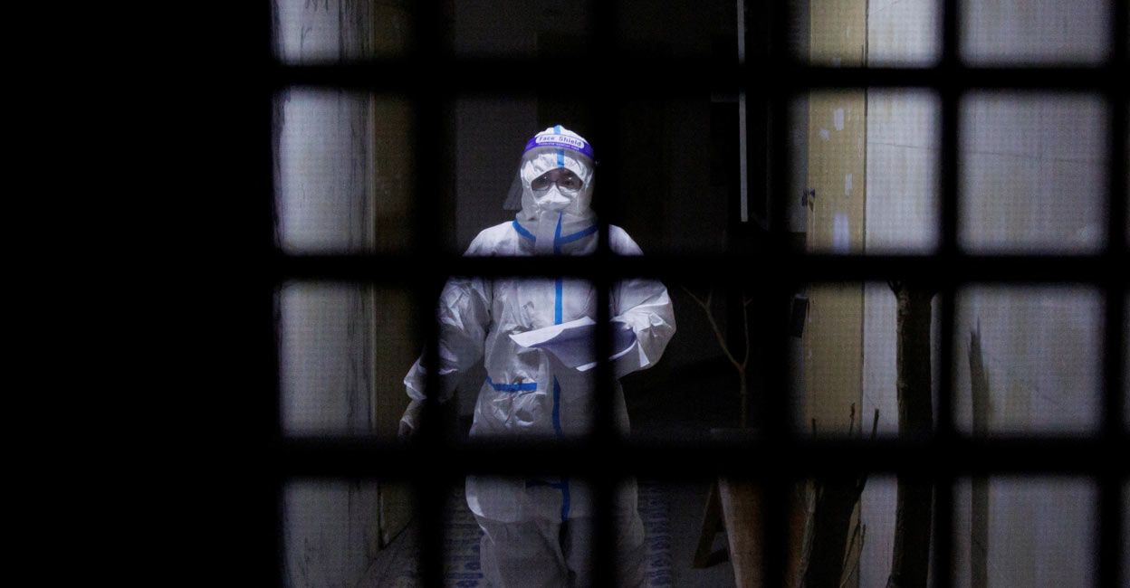 A pandemic prevention worker in a protective suit in Beijing: REUTERS/Thomas Peter